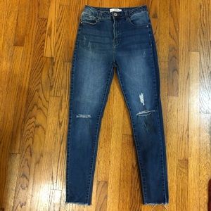 High rise stretch ripped jeans. Dark wash.